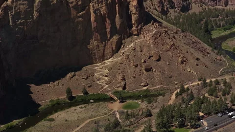 Aerial of Smith Rock State Park hiking trail with zig zag switchbacks Stock Footage 335923751