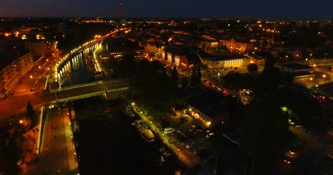 AERIAL. Smooth drone flight through Klaipeda City center at night. Sunset Stock Footage 90644476