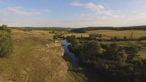 AERIAL: Smooth flight at summer evening countryside nature, over hill valley Stock Footage 78033686