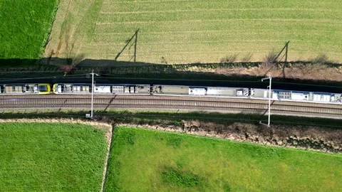 Aerial Snapshot of Train Passing Through Verdant Countryside Stock Footage 268814826
