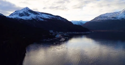 Aerial of snow covered mountain ranges along the lake at dusk 스톡 동영상 79656232