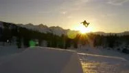 Aerial: Snowboarder Jumping Over A Kicker In Snow Park Stock Footage