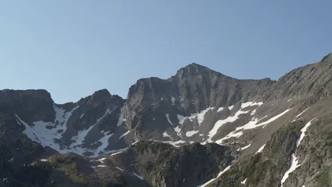 Aerial of snowy cliffs in high alpine mountains in Montana in summer Stock Footage 280006975