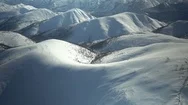 Aerial Of Snowy Mountain Ranges During Winter Stock Footage