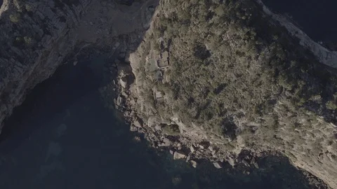 Aerial soft raise up shot of Sa Foradada cliiffs and coast, at Mallorca, Raw 4K Stock Footage 89999641