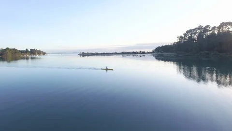 Aerial: Solo kayaker paddling in a yellow kayak Stock Footage