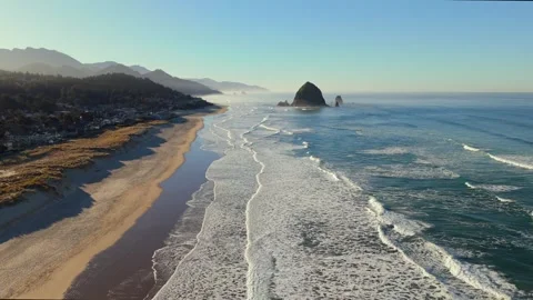 Aerial Southbound Flight Toward Haystack Rock with Cannon Beach Town Stock Footage 300512216