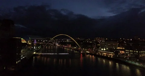 Aerial of Spectacular Gateshead Millenium Bridge at night with lightshow Stock Footage 159145647