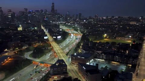 Aerial speed up of traffic on interchange 90, vibrant dusk in River West Stock Footage 321930675