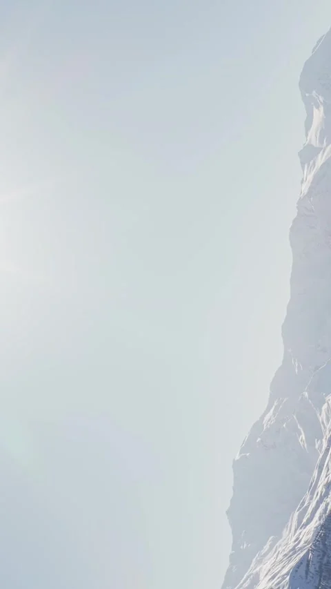 Aerial spinning circular view bright sunburst radiating above snow covered .. Stockbeeldmateriaal 328506855