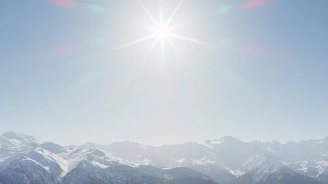 Aerial spinning circular view bright sunburst radiating above snow covered .. Vídeos de archivo 328529673