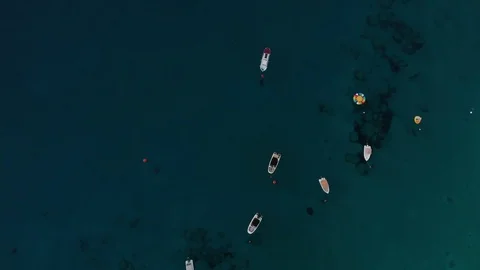 Aerial spinning shot looking down on leisure boats anchored in Konnos Bay Stock Footage 97900766
