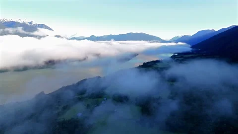 Aerial Spiral Flight Above Clouds in Mountain Shadow at Sunrise Vídeo Stock 334320869