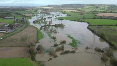 Aerial Spiral Left and Down of Flooded Fields in Wiltshire 스톡 동영상 254785170