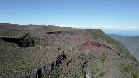 Aerial spiral orbit over massive crater and valley near Piton de la Fournaise Stock Footage 317884820