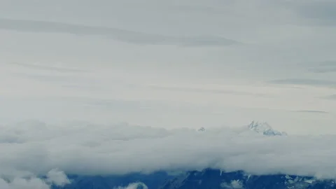 Aerial split frame with clouds and snow mountain peaks Stock Footage 154987728