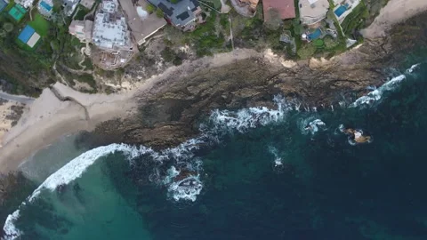 Aerial sprial pull away of oceanside homes overlooking the beach Stock Footage 157188306