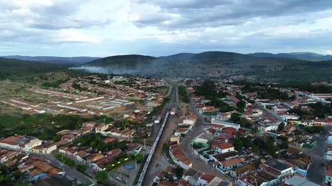 Aerial static medium close view of a train going through a rural town, Brazil. 库存影片 73220907