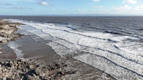 Aerial Static Shot of Long Ocean Waves Breaking on Coastline 4K Stock-Footage 334067432