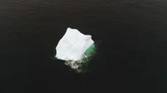 Aerial Static Shot Of One Blue Iceberg Floating Fast In Ocean Water Stock Footage