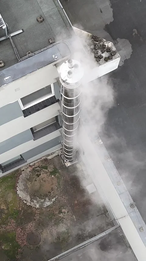 Aerial Static Top Down View of Smoking Chimney on Building Roof Stock Footage 323965527