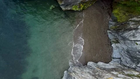 Aerial static top view of a beach with the waves.Drone shot of cliffs in Ireland Stock Footage 167525175