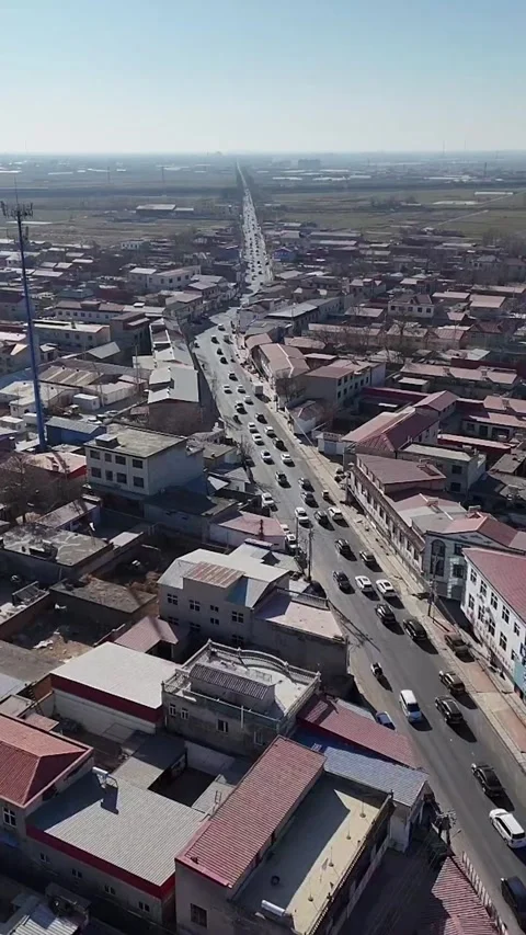 Aerial Static View of Busy Traffic Flowing Through a Small Chinese Town Video stock 330143117