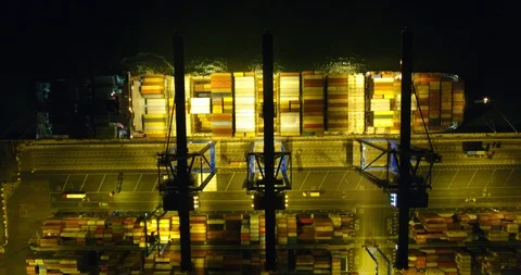 Aerial: static view the container ship anchored in the port quay from above - 16 Stock Footage 98312337