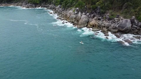 Aerial static view of man supping standup paddleboarding at sea 4k Stock Footage 255877842