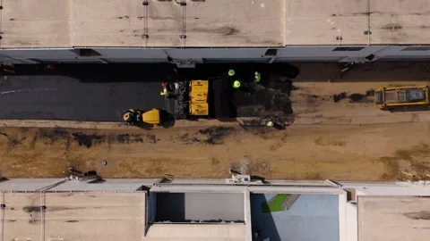 Aerial Static View of Paver Roller and Workers Laying Asphalt on New Street Stock Footage 341898002