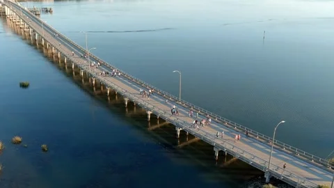 Aerial static view of people walking across a bridge Vídeo Stock 320897124