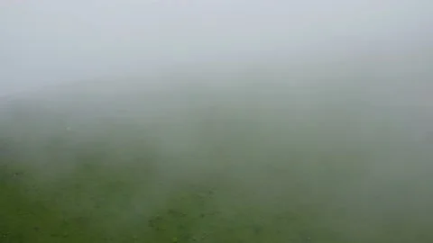 Aerial static view  through mowing clouds horses grazing on meadow in mountains. Stock Footage 165917112