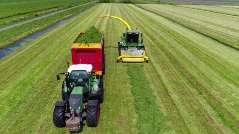 Aerial static view of tractor and trailer and combine harvester 4k Stock Footage 79165775