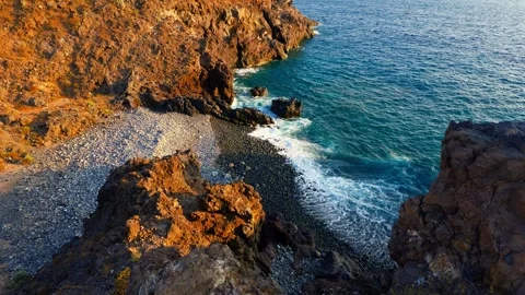Aerial static view of waves hitting rocks at sunset at Ricasa Beach, Erques Stock Footage 345694287