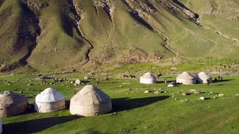 Aerial static view of  yurts in a high mountain valley in Kyrgyzstan. Video stock 328554153