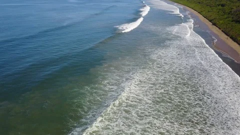 Aerial stationary view of waves rolling in Playa Grande Costa Rica Stock Footage 90972647
