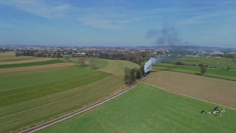 Aerial of a Steam Train With Red Freight Cars Moves Through Vast, Patchwork.. 動画素材 282069962