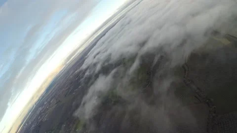 Aerial steep banking turn over cloud layer after sunset Stock Footage 237828702
