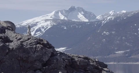 Aerial Stone stack against beautiful snow covered mountain Stock Footage 75045758