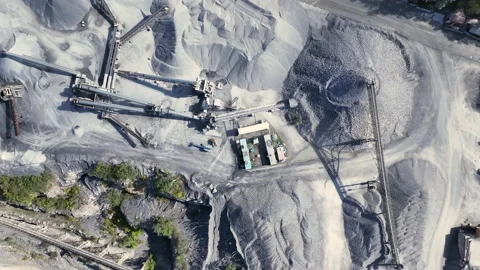 Aerial straight down on active stone quarry and then spins around site Stock Footage 215899005