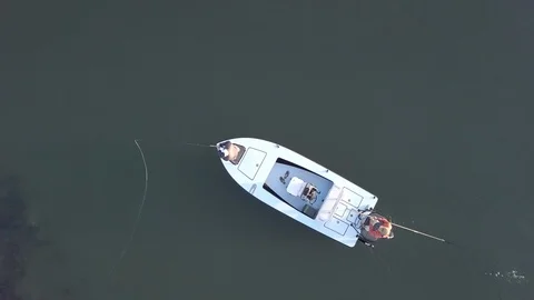 Aerial straight down view of men fly fishing from small boat. Stock Footage 121276083