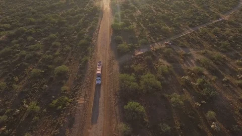 Aerial straight down view of a tractor trailer on a dirt road Stock-Footage 97291963