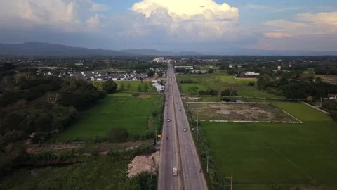 Aerial straight path view above infinite highway crossing rural green lands 스톡 동영상 334482679