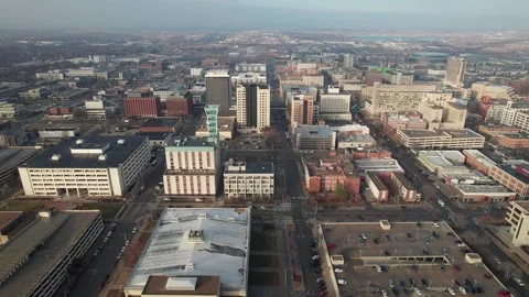 Aerial of structures, business, and traffic in town of Lincoln, NE Stock Footage 242603176
