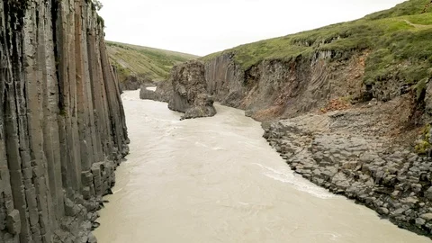 Aerial of Studlagil river with basalt formations hills, Iceland Stock Footage 120489430