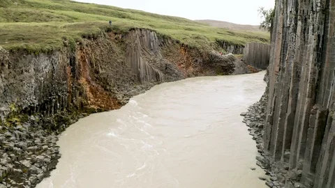 Aerial of Studlagil river with basalt formations hills, Iceland Stock Footage 120489444