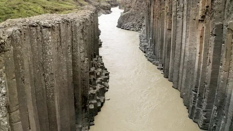 Aerial of Studlagil river with basalt formations hills, Iceland Stock Footage 120489492