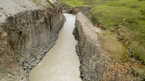 Aerial of Studlagil river with basalt formations hills, Iceland Stock Footage 120489530