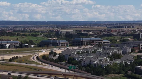 Aerial of suburban development and highway interchange in Lone Tree Colorado Видео 345298509