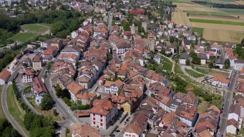 Aerial summer view of Orbe with rooftops and the historic castle tower Video stock 323697346